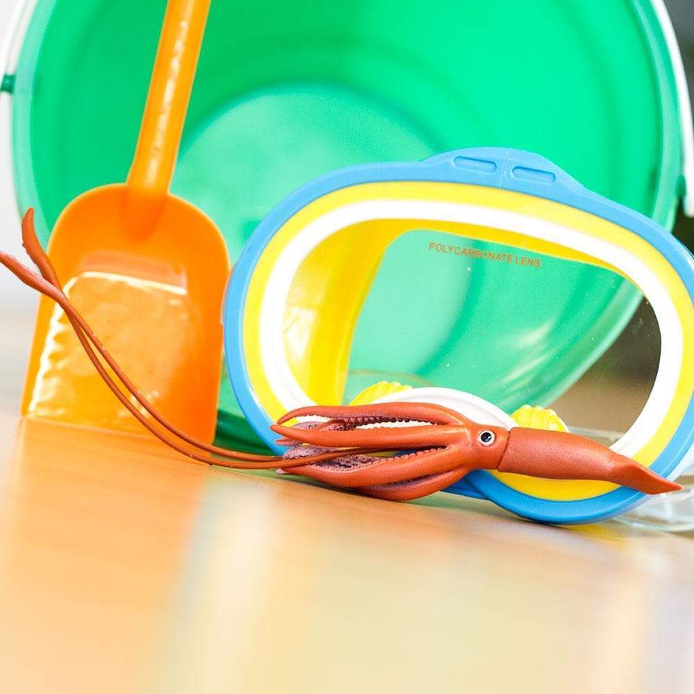 Safari Ltd Giant Squid figurine lifestyle shot with beach toys