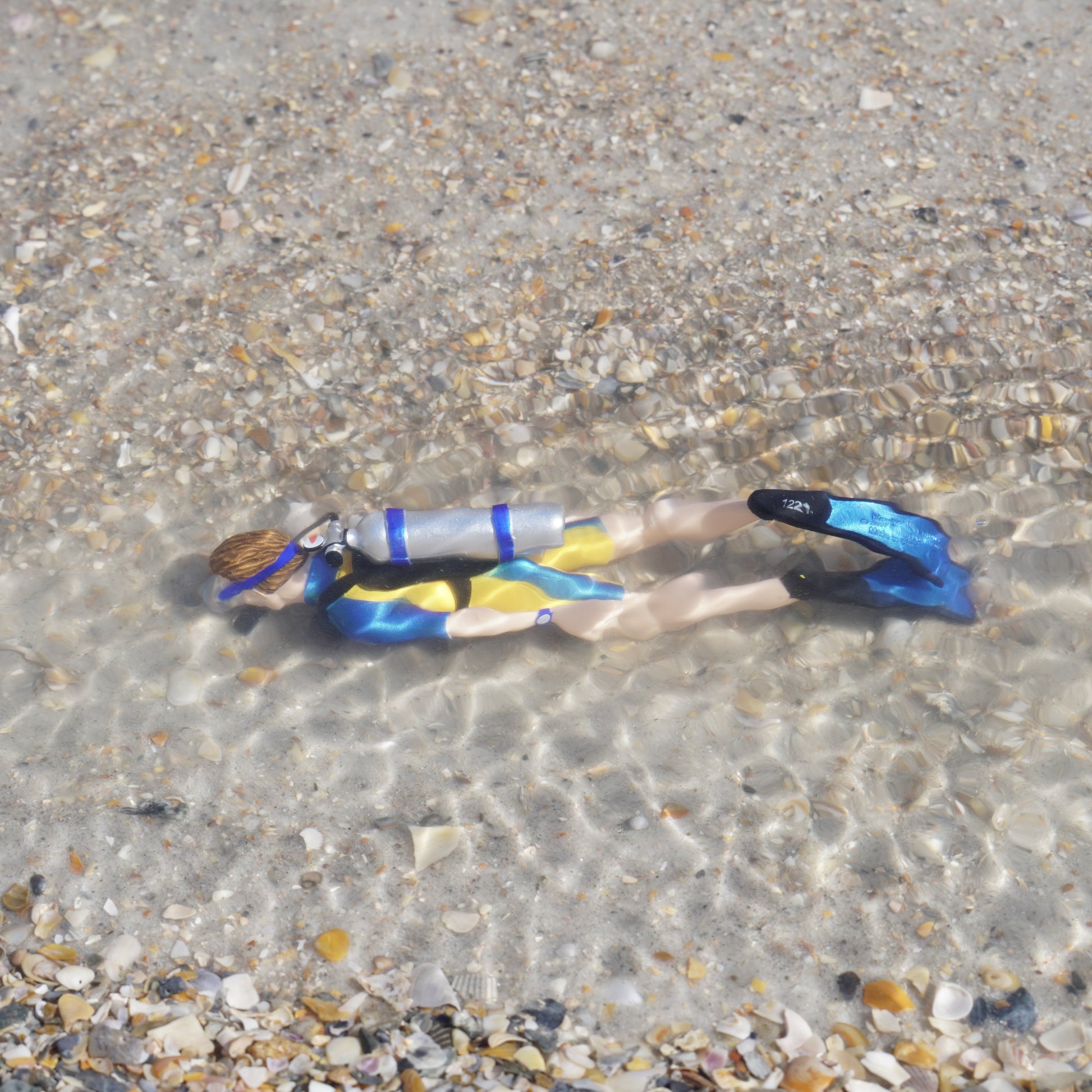 Safari Ltd Kevin scuba diver figurine submerged in shallow ocean water lifestyle shot
